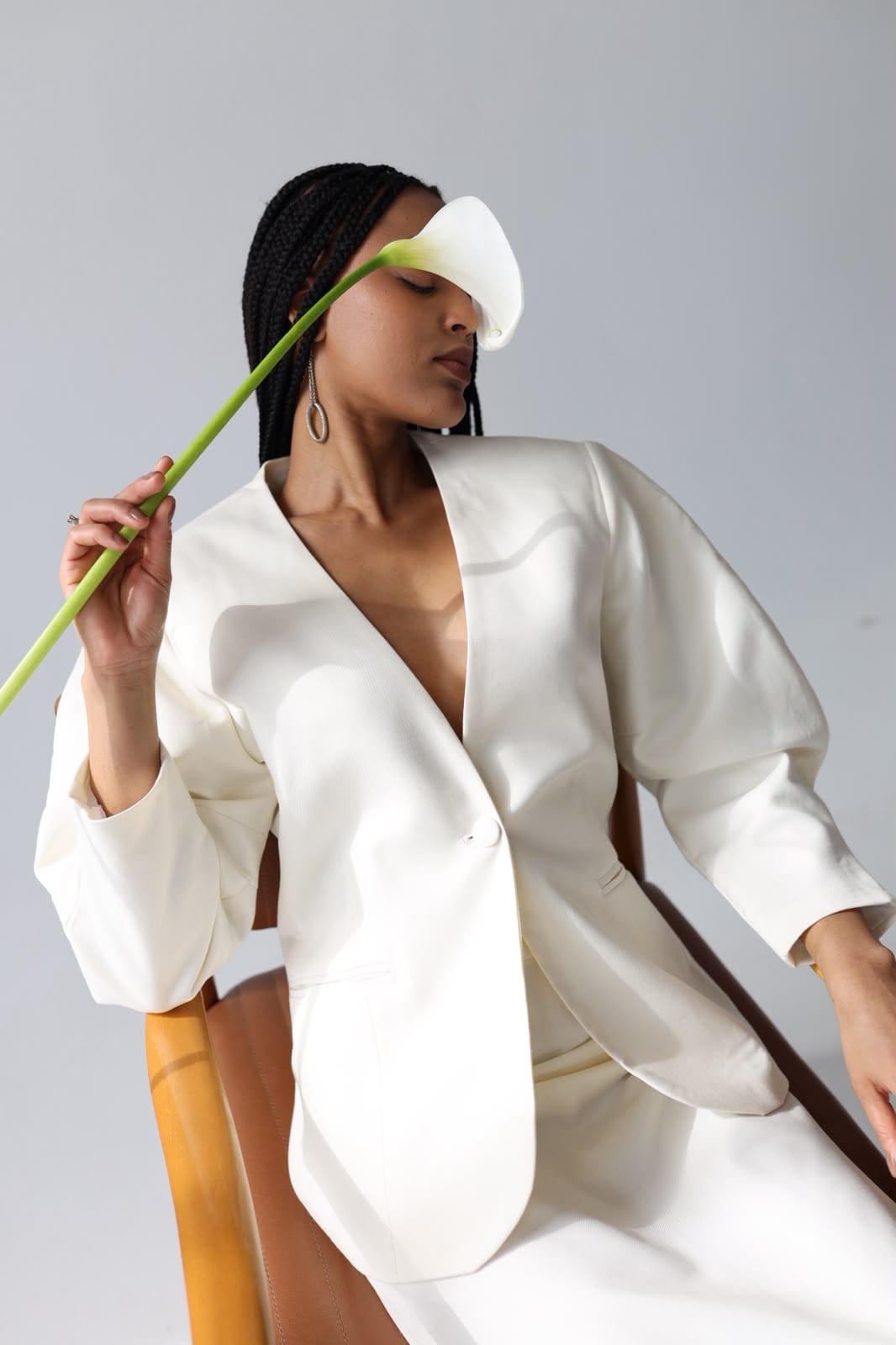 Ivory jacket and skirt, seated